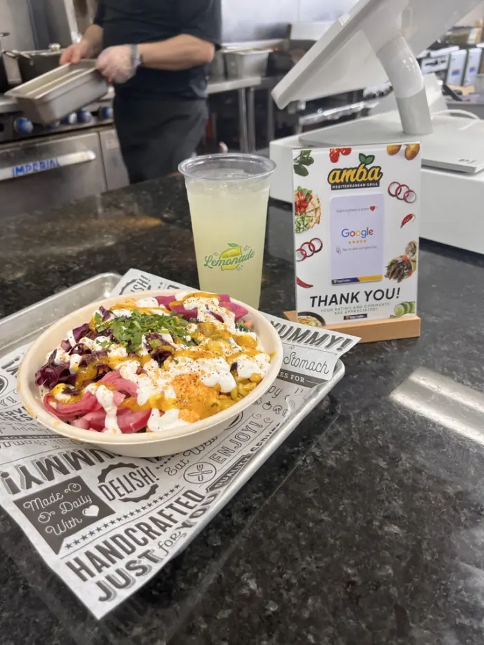 Order counter at Amba with a fresh bowl and lemonade