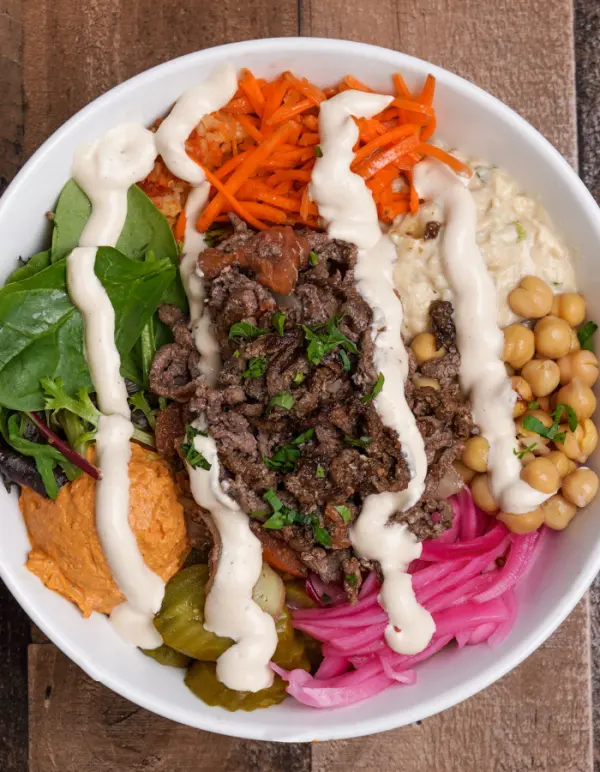 Steak bowl with hummus, carrots, chickpeas and pickled turnip